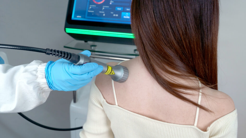 Doctor using Smart Ice Laser Therapy System for patient's neck pain